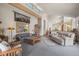 Spacious living room with carpeted floors, large windows, comfortable sofas, and stylish decor at 6584 Pike Cir, Larkspur, CO 80118