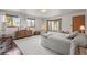 Bright main bedroom boasts scenic views from multiple windows and cozy seating area at 6584 Pike Cir, Larkspur, CO 80118