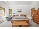 Bright main bedroom featuring a wooden platform bed with storage, and neutral decor, creating a serene retreat at 6584 Pike Cir, Larkspur, CO 80118
