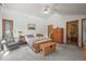 Bright main bedroom featuring a wooden platform bed with storage, and neutral decor, creating a serene retreat at 6584 Pike Cir, Larkspur, CO 80118