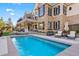 Backyard with a large pool, patio seating, and a well-manicured lawn at 4541 Tierra Alta Dr, Castle Rock, CO 80104