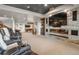 Finished basement with a large stone fireplace, theater seating, and a pool table in the background at 4541 Tierra Alta Dr, Castle Rock, CO 80104