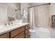 Well-maintained bathroom featuring a single sink, wooden vanity, and tiled shower-tub combination at 4541 Tierra Alta Dr, Castle Rock, CO 80104