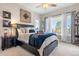Bedroom featuring a view, large windows, stylish décor, and a comfy king-size bed at 4541 Tierra Alta Dr, Castle Rock, CO 80104