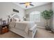 Cozy bedroom with neutral tones, plush bedding, a ceiling fan, and soft natural light at 4541 Tierra Alta Dr, Castle Rock, CO 80104