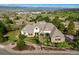 Stunning aerial view of a grand estate home with lush landscaping and mountain views at 4541 Tierra Alta Dr, Castle Rock, CO 80104