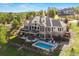 Expansive two-story home with a pool, stone accents, outdoor patio, and lots of natural light at 4541 Tierra Alta Dr, Castle Rock, CO 80104