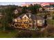 An aerial dusk view of a home featuring an illuminated outdoor living area and landscaped yard at 4541 Tierra Alta Dr, Castle Rock, CO 80104
