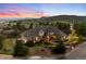 Dusk view of a home with landscaped front yard, stone exterior, and illuminated windows at 4541 Tierra Alta Dr, Castle Rock, CO 80104