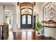 Elegant foyer featuring a large entry door, hardwood floors, and stylish decor at 4541 Tierra Alta Dr, Castle Rock, CO 80104