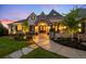 Inviting front entrance with double doors, stone accents, lush landscaping, and a curved walkway leading to the home at 4541 Tierra Alta Dr, Castle Rock, CO 80104
