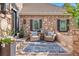 Cozy front porch with stone accents, comfortable seating, and stylish outdoor rug at 4541 Tierra Alta Dr, Castle Rock, CO 80104