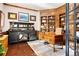 Wood paneled office featuring custom shelving, a large desk, and sophisticated decor at 4541 Tierra Alta Dr, Castle Rock, CO 80104