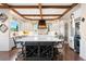 Bright, spacious kitchen featuring a large center island with wine rack, beamed ceilings, and modern appliances at 4541 Tierra Alta Dr, Castle Rock, CO 80104