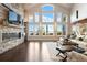 Spacious living room filled with natural light, featuring a stone fireplace and scenic views at 4541 Tierra Alta Dr, Castle Rock, CO 80104
