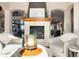 Cozy living room with a fireplace and views of the outdoors through large arched doorways at 4541 Tierra Alta Dr, Castle Rock, CO 80104