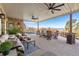 Covered patio with seating area, ceiling fans, and views of a pool and the mountains at 4541 Tierra Alta Dr, Castle Rock, CO 80104