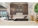 Wet bar with a marble counter, dark wood cabinets, wine storage, and a scenic outdoor view at 4541 Tierra Alta Dr, Castle Rock, CO 80104
