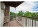 Private outdoor balcony with stone siding and a wooded view overlooking the parking area at 381 S Ames St # F204, Lakewood, CO 80226