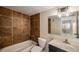 Updated bathroom featuring large vanity, decorative lighting, shower/tub combo with unique tile surround at 381 S Ames St # F204, Lakewood, CO 80226