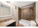 Updated bathroom with granite vanity, stylish tiling in the shower/tub combination, and vinyl floor at 381 S Ames St # F204, Lakewood, CO 80226