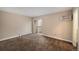 Bedroom with tan carpet, baseboard heating, and sliding glass doors to a private deck at 381 S Ames St # F204, Lakewood, CO 80226