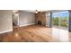 Bright living room features beautiful stone fireplace, hardwood floors, and sliding glass door to balcony at 381 S Ames St # F204, Lakewood, CO 80226