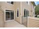 Back of the property showcasing the patio area, private gate, and tan siding at 8307 S Garland Cir, Littleton, CO 80128