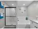 Bright bathroom featuring a separate tub and a glass-enclosed tiled shower at 8307 S Garland Cir, Littleton, CO 80128