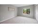 Cozy bedroom featuring a large window and neutral tones at 8307 S Garland Cir, Littleton, CO 80128