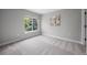 Neutral-toned bedroom with carpeted floors and a window providing natural light at 8307 S Garland Cir, Littleton, CO 80128