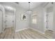 Dining area with modern light fixture, neutral walls, and wood-look flooring at 8307 S Garland Cir, Littleton, CO 80128