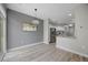 Open dining area with modern light fixture and adjacent to the kitchen with stainless steel appliances at 8307 S Garland Cir, Littleton, CO 80128