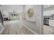 Inviting entryway with stylish decor, light wood floors, and views into the living room and kitchen at 8307 S Garland Cir, Littleton, CO 80128
