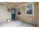 Charming front porch with a blue door, decorative wreath, and a welcoming flower arrangement at 8307 S Garland Cir, Littleton, CO 80128