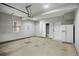 Spacious two-car garage featuring ample storage space, a garage door opener, and a refrigerator at 8307 S Garland Cir, Littleton, CO 80128