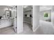 Hallway featuring bathroom vanity, walk-in closet and views to the Primary bedroom at 8307 S Garland Cir, Littleton, CO 80128