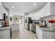 Bright kitchen with stainless steel appliances, granite countertops, and view to the outdoor patio at 8307 S Garland Cir, Littleton, CO 80128