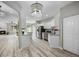 Bright, updated kitchen featuring stainless steel appliances, granite countertops, and a modern chandelier at 8307 S Garland Cir, Littleton, CO 80128