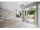 Open-concept living room with fireplace, sliding glass door to the patio and light wood flooring at 8307 S Garland Cir, Littleton, CO 80128