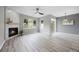 Bright living room with light wood floors, a modern fireplace and sliding glass door to patio at 8307 S Garland Cir, Littleton, CO 80128