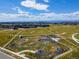 Aerial view of the Beeler Park open space featuring a pump track and walking paths with views at 5716 Boston Ct, Denver, CO 80238
