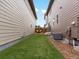 Sideyard featuring manicured synthetic grass, a deck with chairs, and fence at 5716 Boston Ct, Denver, CO 80238