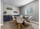Basement dining area with a modern table, chairs, and a stylish wet bar at 5716 Boston Ct, Denver, CO 80238