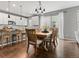 Cozy dining area with wood table, stylish lighting, and view of modern kitchen at 5716 Boston Ct, Denver, CO 80238