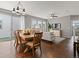 Open floor plan integrating dining and living areas with hardwood floors and ample light at 5716 Boston Ct, Denver, CO 80238