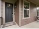 Inviting front entrance with a modern door, stylish hardware, and a welcoming mat at 5716 Boston Ct, Denver, CO 80238