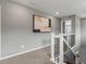 Hallway features a gray accent wall, white railing, and a decorative art piece at 5716 Boston Ct, Denver, CO 80238