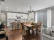 Modern kitchen with white cabinets, stainless steel appliances, and a spacious dining area at 5716 Boston Ct, Denver, CO 80238