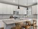 Bright kitchen boasts modern lighting, stainless appliances, and a large kitchen island with seating at 5716 Boston Ct, Denver, CO 80238